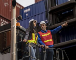 workers in high visibility safety gear and hard hats discuss operations